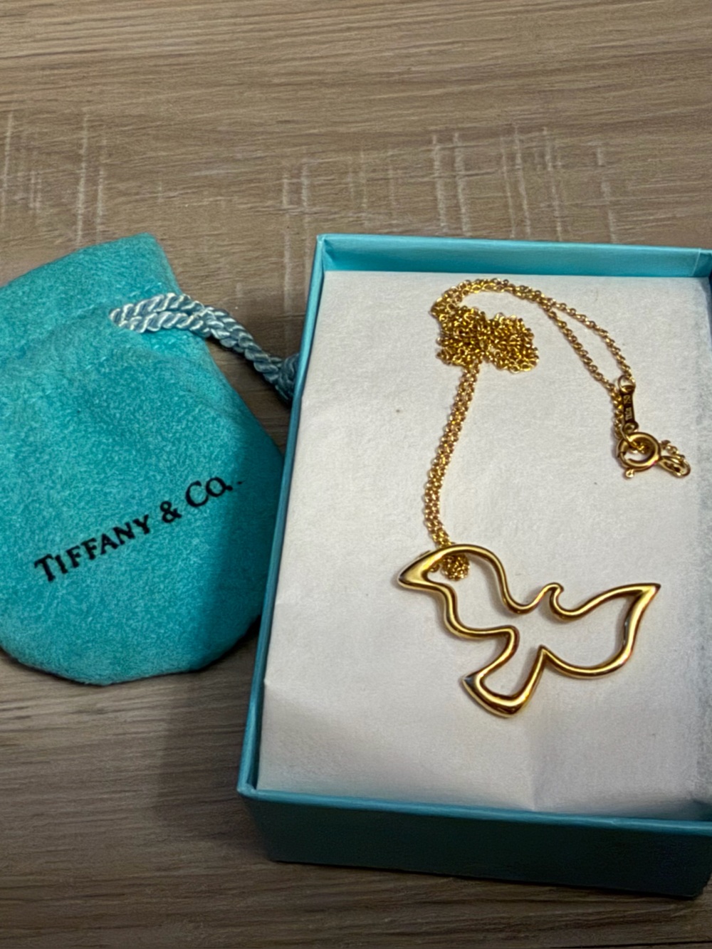 Priced to sell- Tiffany & Co. 18 K Gold Dove Pendant Necklace with Blue Pou